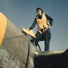 WASP climbing into a Lockheed P-38 preparatory to ferrying mission