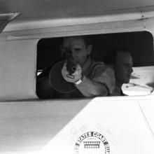 A photo of a Coast Guardsman during a demonstration on handling drug smuggling.