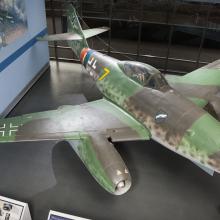 Top view of a green and gray camouflage fighter military monoplane with two engines. Monoplane is on display in the Museum.