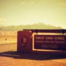 Filtered image of the welcome sign for the Great Sand Dunes. 