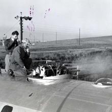 Two men on top of aircraft