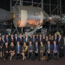 Two rows of people in suits seated for portrait