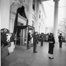 Jacqueline Kennedy, holding the hands of her children John and Caroline, exits the White House on the day of President John F. Kennedy's funeral. 