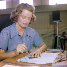 Elizabeth Holbrook and many other WAVES work in a huge assembly and repair building at a Naval Air Station in Hawaii