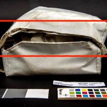 Before conservation, a section of the container’s lid is missing on the left side of the medical kit (indicated in red).