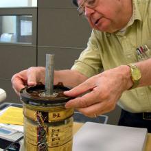 George Ludwig fitting his cosmic-ray detector with the Museum's Explorer 1 satellite.