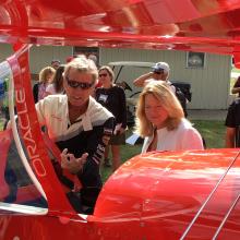 Dr. Ellen Stofan with Aviator Sean D. Tucker and his Oracle Challenger III biplane.