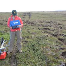 The author using a ground penetrating radar system to image the location of the soil-bedrock boundary. 