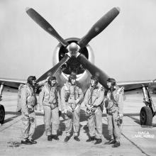 In 1945, test pilots Mel Gough, Herb Hoover, Jack Reeder, Steve Cavallo, and Bill Gray stand in front of a P-47 Thunderbolt.