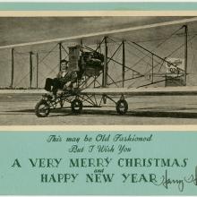 Christmas Card with photo of a man flying a Curtiss aircraft