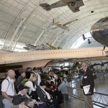 A group of veterans touring the Steven F. Udvar-Hazy Center in Chantilly, VA with a docent.