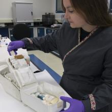 Engen Pre-program Conservation Fellow Meghann Kozak examines the Apollo 11 medical accessory kit in the Museum’s Emil Buehler Conservation Laboratory. 