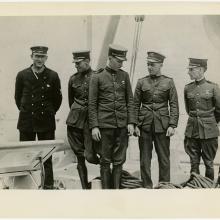 Five men in naval uniforms