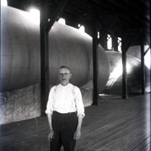 Man in front of balloon in factory