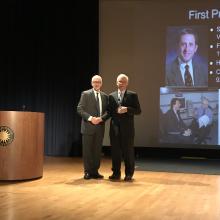  David Skorton and Michael Neufeld pose on stage.