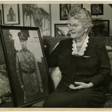 Mother Tusch sitting on a couch at her home