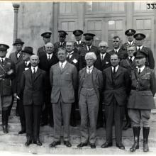 Group of men on stairs in front of a building