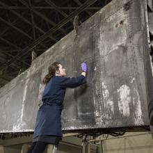 woman looks at aircraft paint