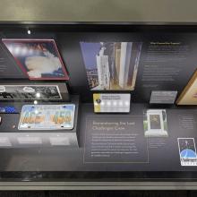 A display case in the Moving Beyond Earth exhibition, commemorating the Challenger launch tragedy.