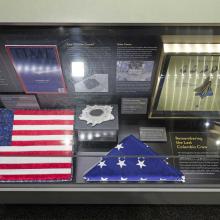 A display case in the Moving Beyond Earth exhibition, commemorating the Columbia return tragedy.