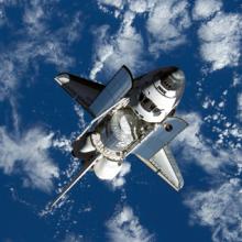 Space shuttle Discovery approaches International Space Station during STS-120 mission.