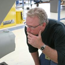  ILM model maker John Goodson studies the hangar deck at the back of the ship’s engineering hull. 