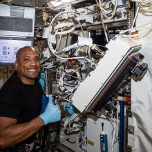 NASA astronaut and Expedition 64 Flight Engineer Victor Glover is pictured inside Japan's Kibo laboratory module installing research gear. He is looking at the camera and smiling. He is giving a thumbs up!