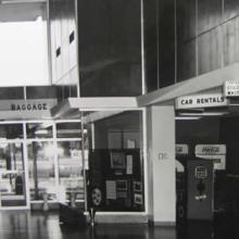 Image of the airport waiting room that shows a sign on right to a sitting area for African Americans.