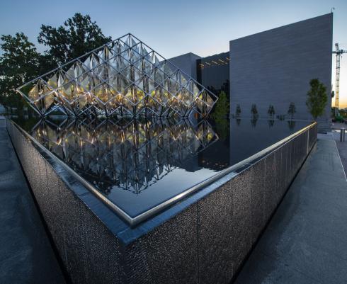 A statue in a water feature stands in front of the National Air and Space Museum.