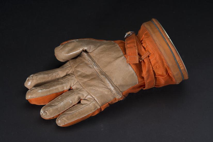 An orange glove, palm up.