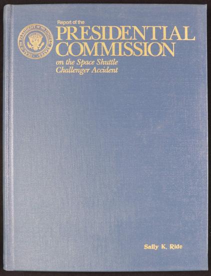 A canvas bound book cover with metallic lettering "Report of the Presidential Commission on the Space Shuttle Challenger Accident."