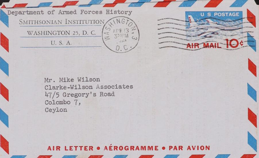 Air Letter address side: red, white and blue diagonal striped pattern around border, Smithsonian letter head in upper left-hand corner, postmark in upper middle, 10 cent stamp featuring red and white and blue airplane. Address in center of page