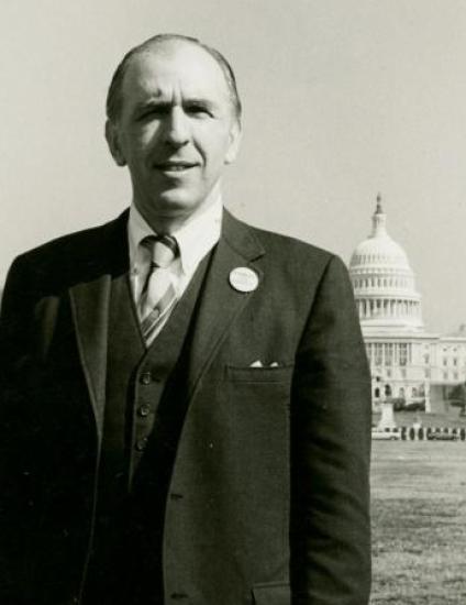 A man with a briefcase in front of the Capital.