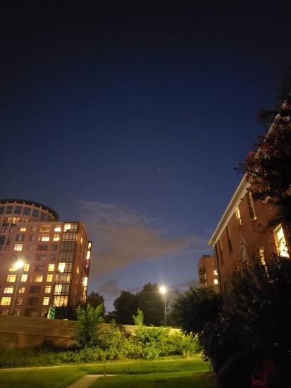 A photo of the night's sky in DC between two buildings.