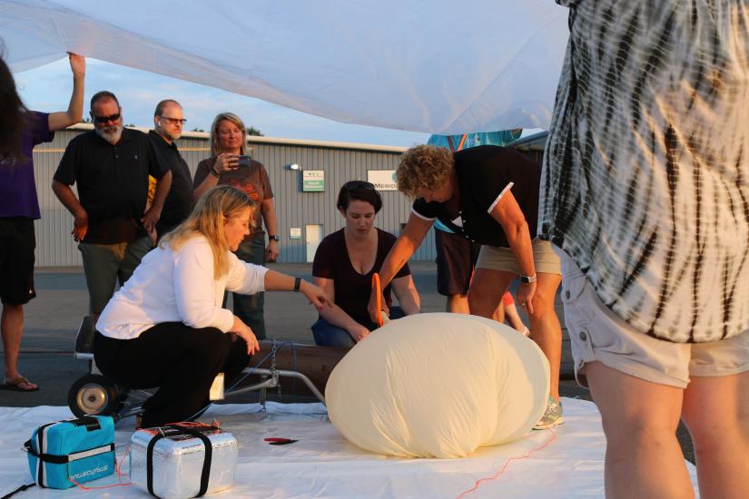 Teachers and former museum director Ellen Stofan inflate something.
