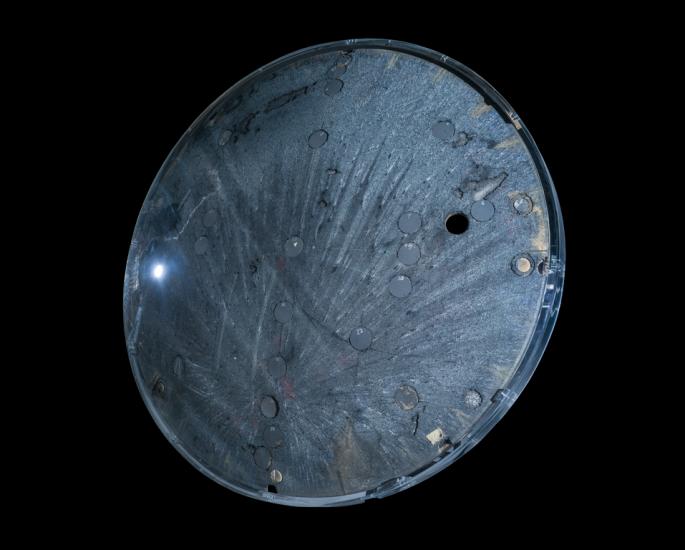 Underside view of a space capsule. The background of the image is black. 