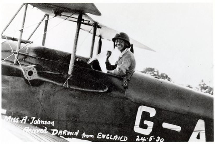 A woman in the flight deck of an airplane.