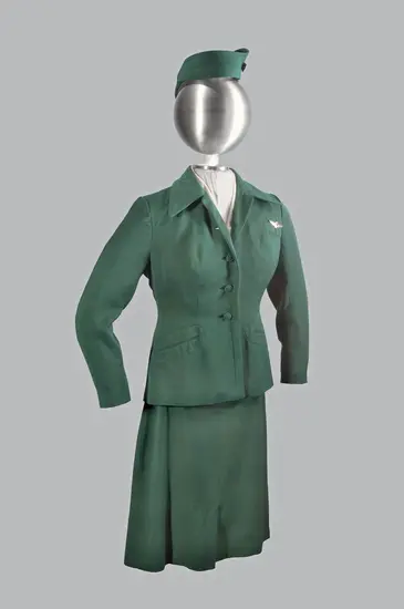 A photograph of a green colored uniform on a mannequin.