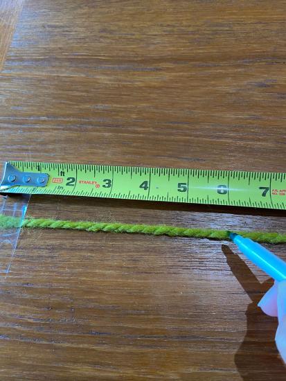 A string stretched against a measuring tape.