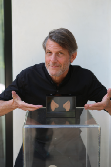 Man in black shirt points to Spock ears in a box