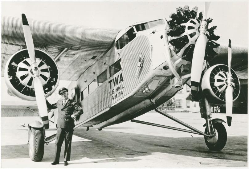 Transcontinental and Western Air Pilot Arthur Burns standing in front of a Ford 5-AT Tri-Motor