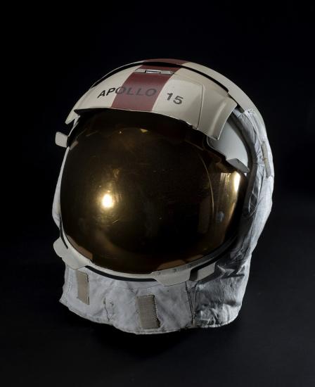 A helmet with a reflective face shield and Apollo 15 written across the visor. 