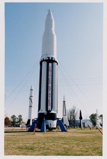 A large rocket labeled "United States" stands in the middle of a field.