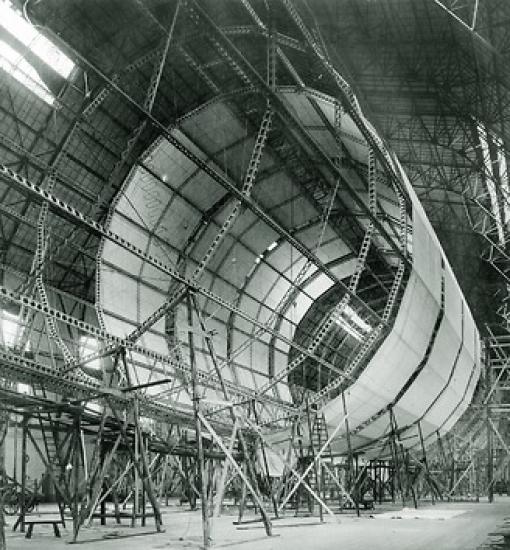 The framework of an airship. Half of the frame is covered in material.