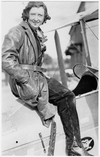 Black and white image of Maude Rose Rubens "Lores" Bonney sitting at the top of an aircraft.