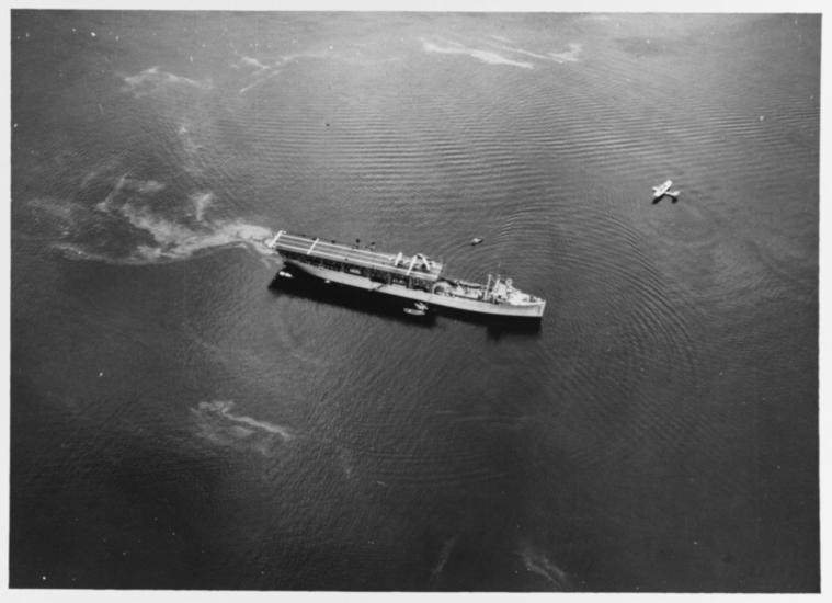 Black and white grainy image of USS Langley in ocean