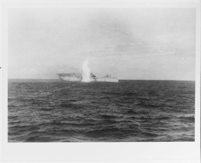 Black and white grainy image of the USS Langley under attack