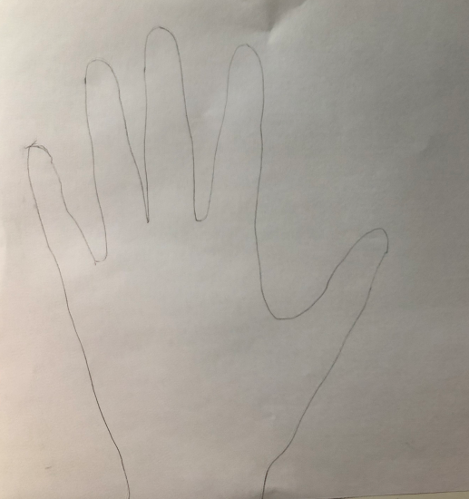 A drawing of an outline of a hand on paper. 