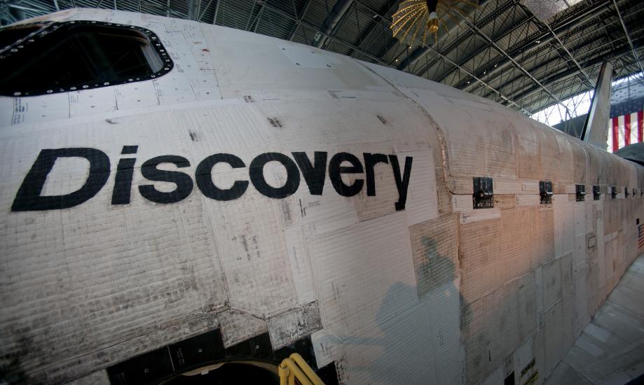 A close up shot of the nose of the Discovery. The word "discovery" is visible, as is a window. The side of discovery appears to be a quilted texture.