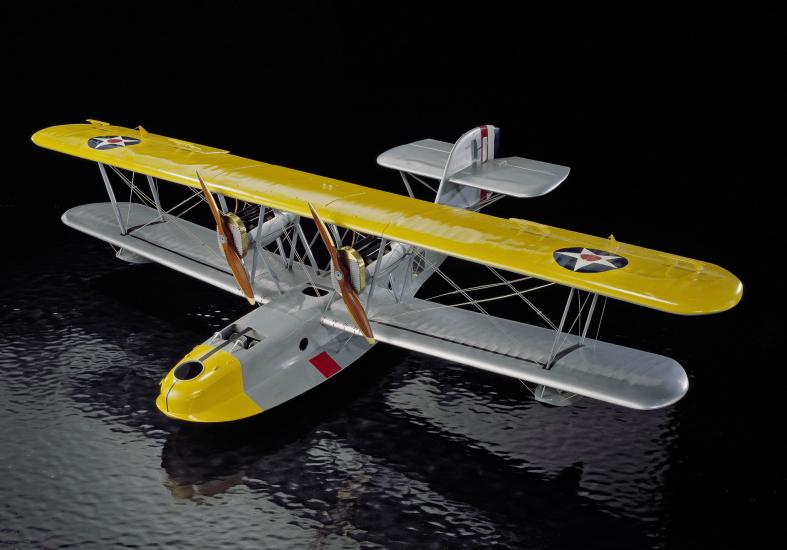 A grey biplane with two propellers with yellow details. 